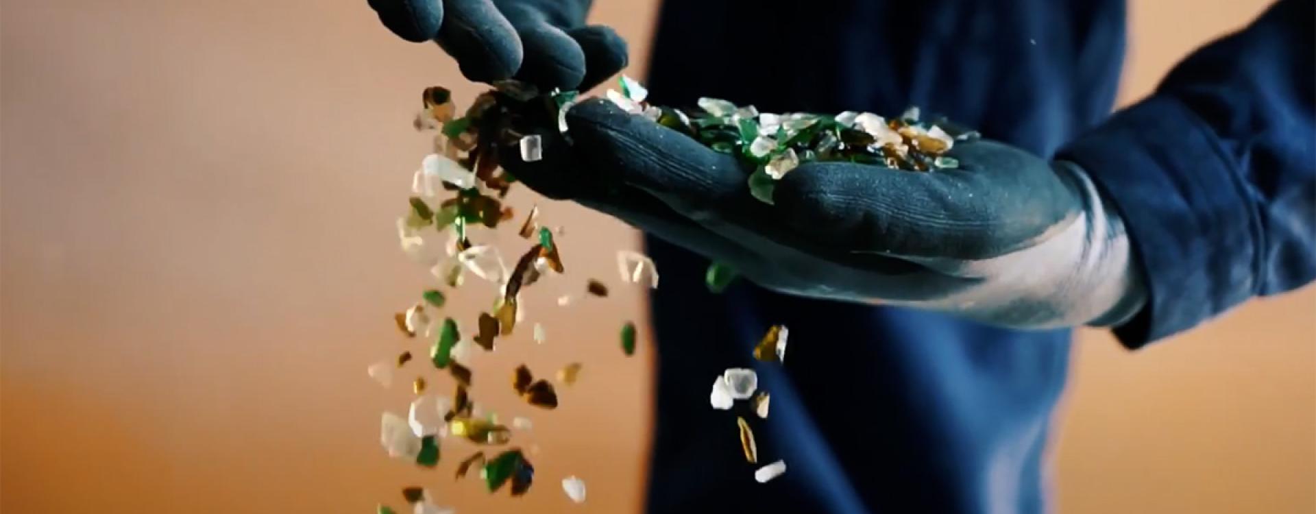 Hand with processed glass granules